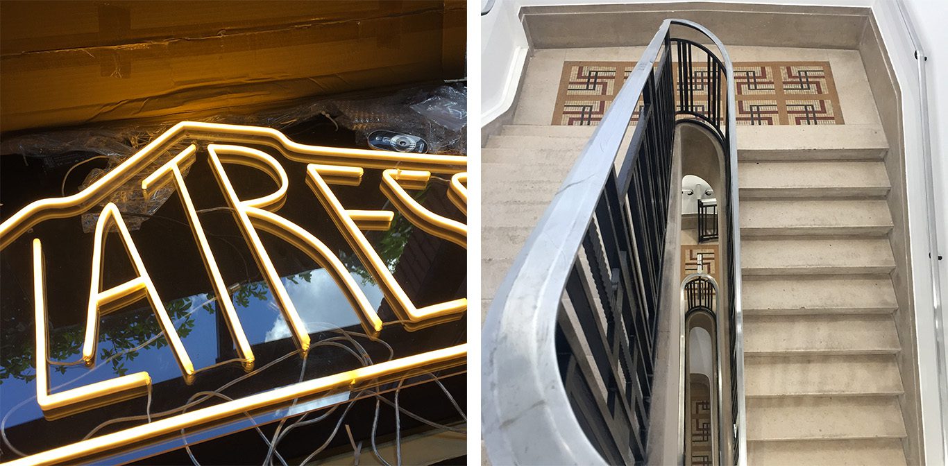 Enseigne lumineuse La Tréso en cours de pose et cage d’escalier avec rampe noire et paliers en mosaïque