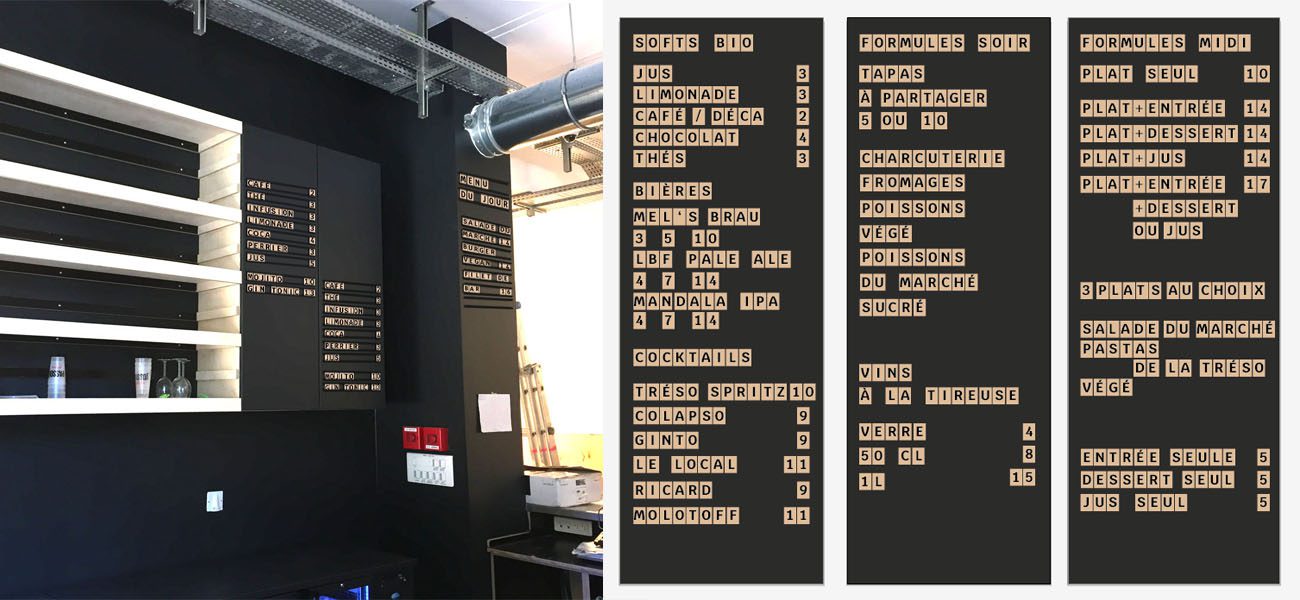 Panneaux de signalétique menu en lettres mobiles sur murs noirs dans un tiers-lieu avec tarifs lisibles